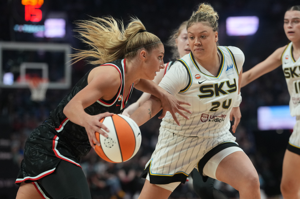Portland Fire guard Sarah Ashlee Barker, left, tries to get past Chicago Sky guard Rachel Banham (24) during the first half of a WNBA basketball game on Saturday, May 9, 2026, in Portland, Ore. (AP Photo/Jenny Kane)