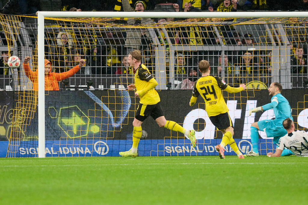 Borussia's Julian Brandt celebrates with teammates after scoring the opening goal during Germany Bundesliga soccer match between Borussia Dortmund and TSG 1899 Hoffenheim, in Dortmund, Germany, Sunday, Dec. 7, 2025. (Bernd Thissen/dpa via AP)