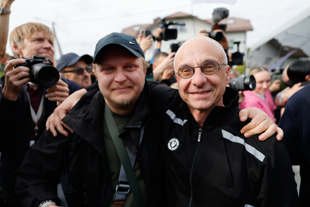 Dzmitry Navazhylau, right, one of the released Belarusian prisoners, is welcomed by his colleagues upon his arrival in Vilnius, Lithuania, Wednesday, Sept. 16, 2026. (AP Photo/Mindaugas Kulbis)