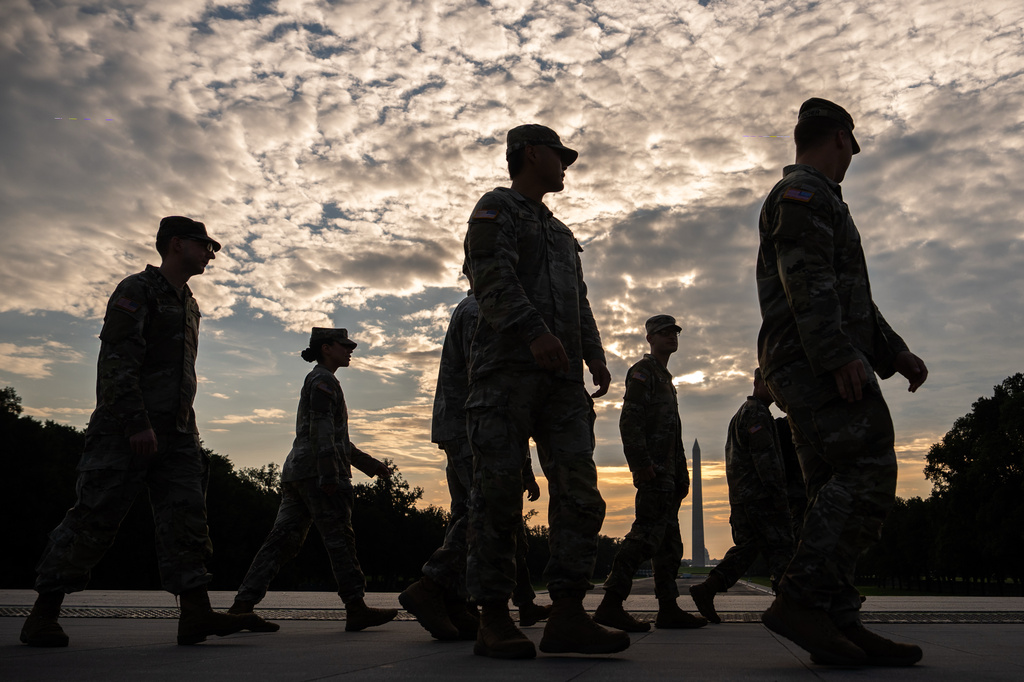 Members of the National Guard walk past the Lincoln Memorial Reflecting Pool before the March on Washington, Friday, Aug. 28, 2026, in Washington. (AP Photo/Julia Demaree Nikhinson)
