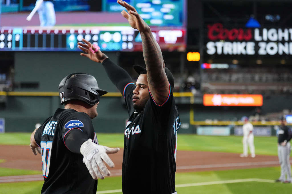 Miami Marlins' Jakob Marsee, left, celebrates his two-run home run against the Arizona Diamondbacks with Marlins' Deyvison De Los Santos during the third inning of a baseball game, Wednesday, Sept. 16, 2026, in Phoenix. (AP Photo/Ross D. Franklin)