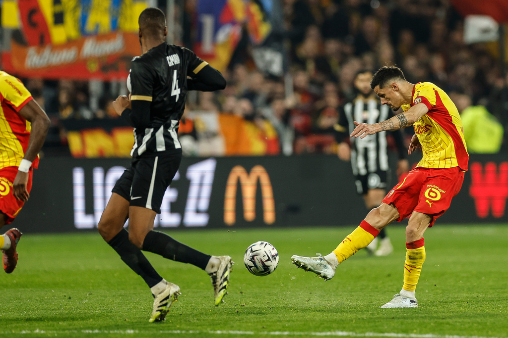 Lens' Sotoca Florian shoots at goal during the French League One soccer game between Lens and Angers, Friday, March 20,2 026, in Lens, France. (AP Photo/Jean-Francois Badias)
