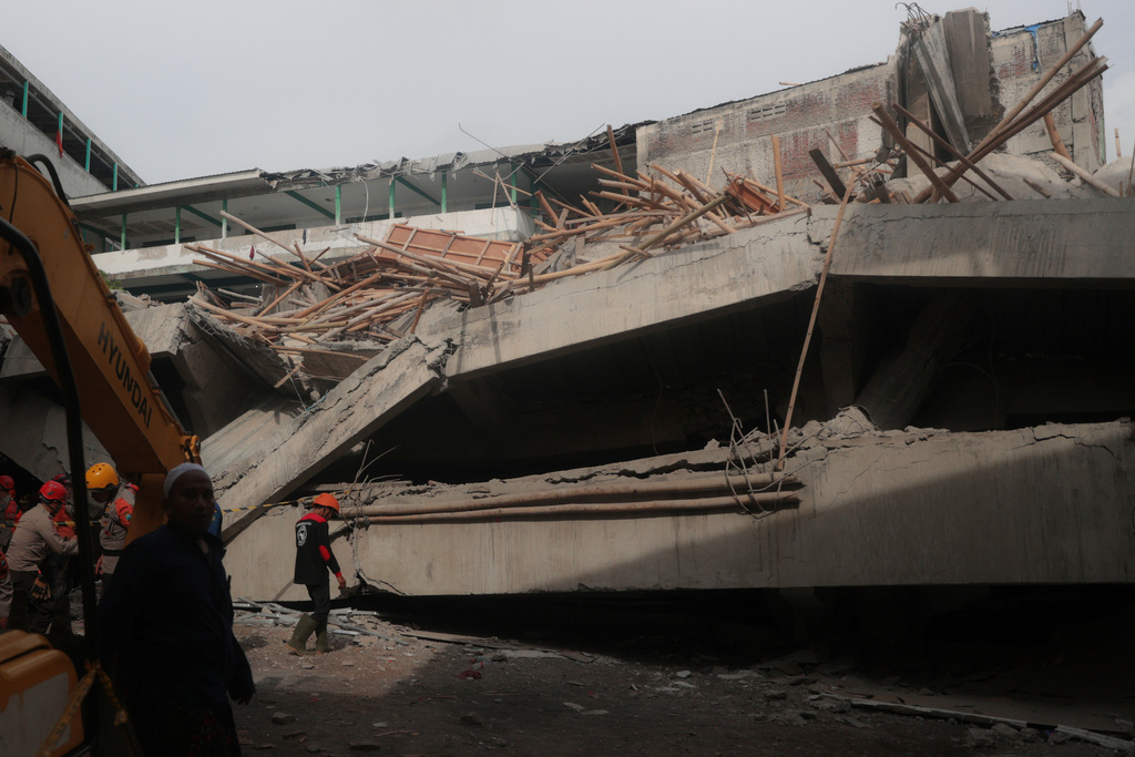 Rescuers search for survivors after a building under construction collapsed, at an Islamic boarding school in Sidoarjo, East Java, Indonesia, Tuesday, Sept. 30, 2025. (AP Photo/Trisnadi)