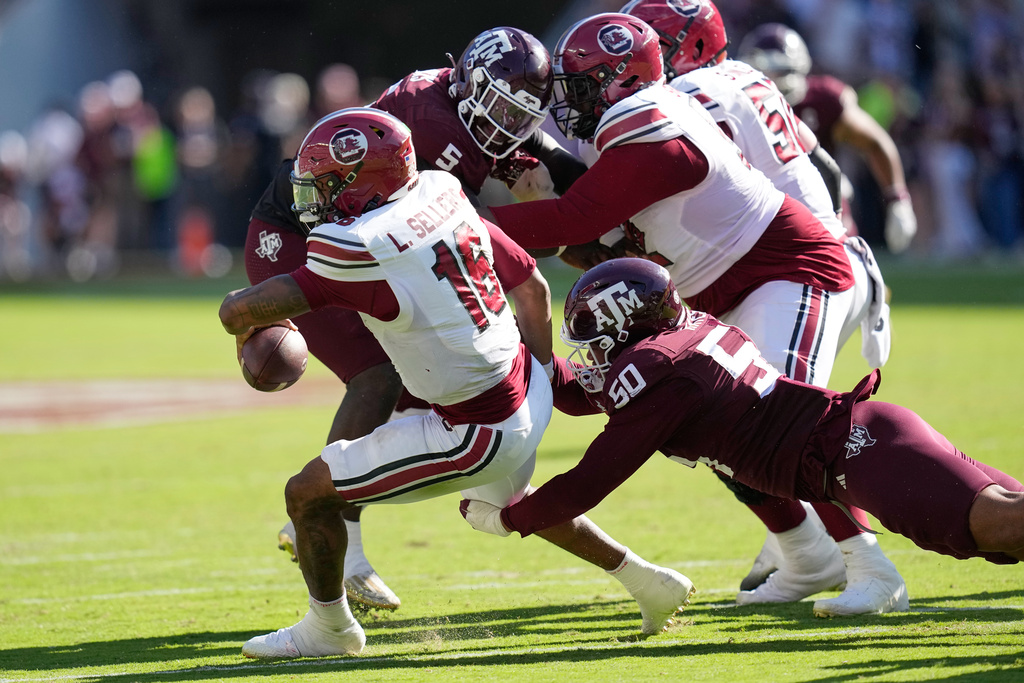South Carolina quarterback Lanorris Sellers (16) is sacked by Texas A&M defensive end Dayon Hayes (50) during the second half of an NCAA college football game Saturday, Nov. 15, 2025, in College Station, Texas. (AP Photo/David J. Phillip)