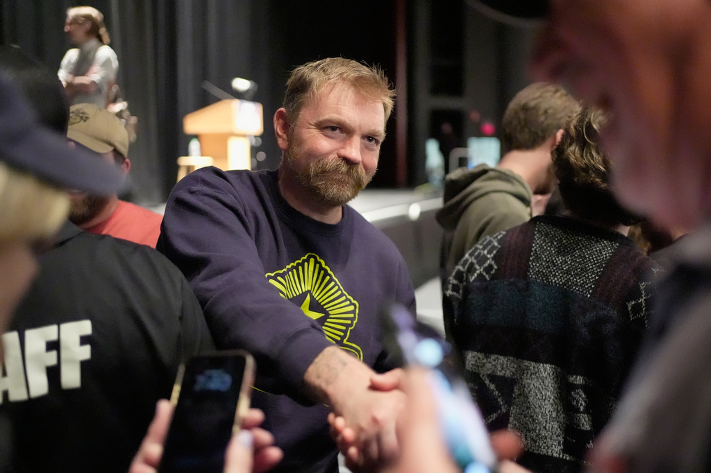 Graham Platner, Democratic candidate for U.S. Senate, greets supporters after speaking at an event hosted by Sen. Bernie Sanders in Orono, Maine, Sunday, May 24, 2026. (AP Photo/Robert F. Bukaty)