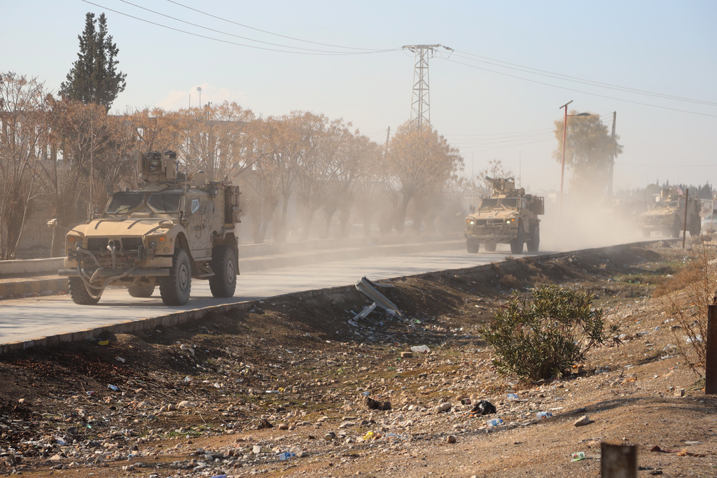 U.S. military vehicles from the U.S.-led coalition against the Islamic State group drive through Deir Hafer, Syria, Friday, Jan. 16, 2026, before a meeting with the U.S.-backed Syrian Democratic Forces. (AP Photo/Baderkhan Ahmad)