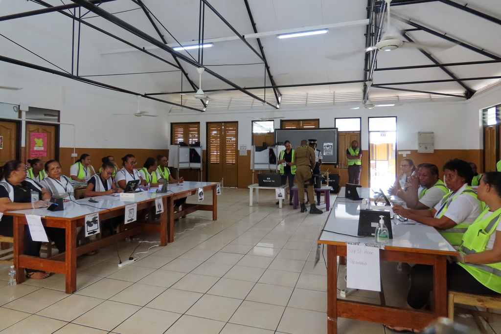 Electoral commission staff monitor voting, inside a classroom as people cast their votes at the polling station at English River School in Victoria, Seychelles, Thursday, Sept. 25, 2025. (AP Photo/Emilie Chetty)