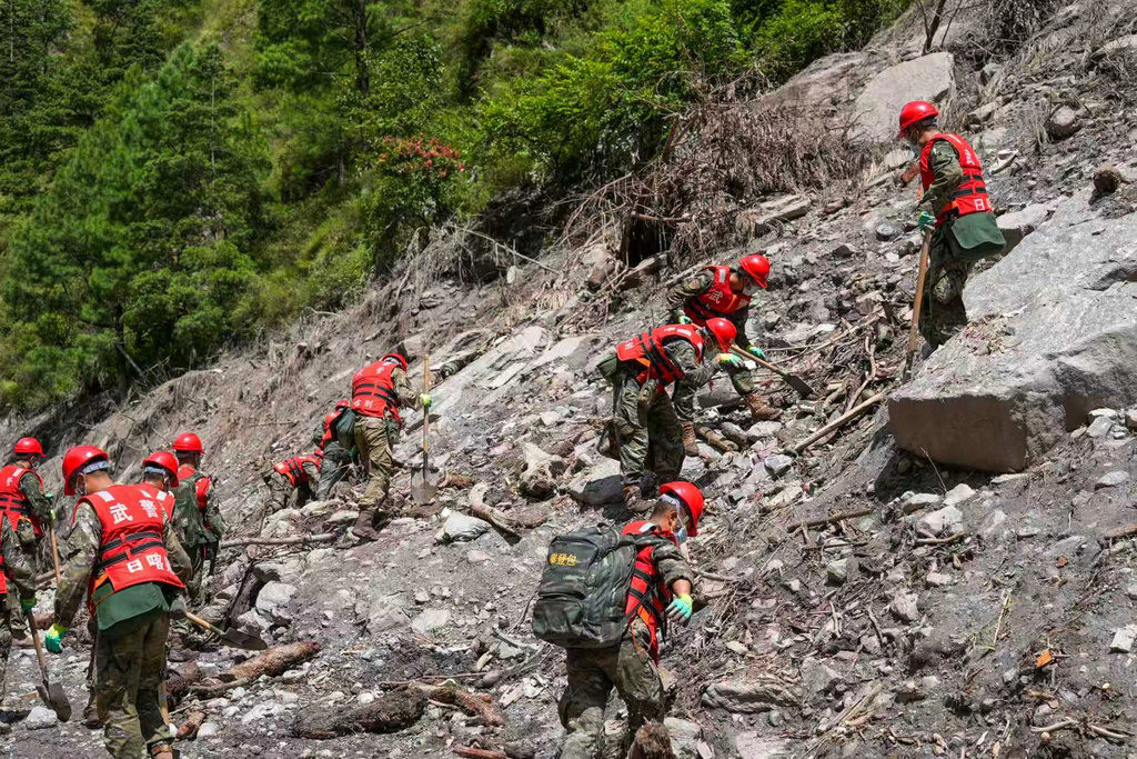 In this photo released by Xinhua News Agency, rescuers from the People's Armed Police Force work at the mudslide-hit area near Gyirong Port in Gyirong County, in Xigaze, southwest China's Tibet Autonomous Region on Friday, Aug. 28, 2026. (Liu Shuang/Xinhua via AP)