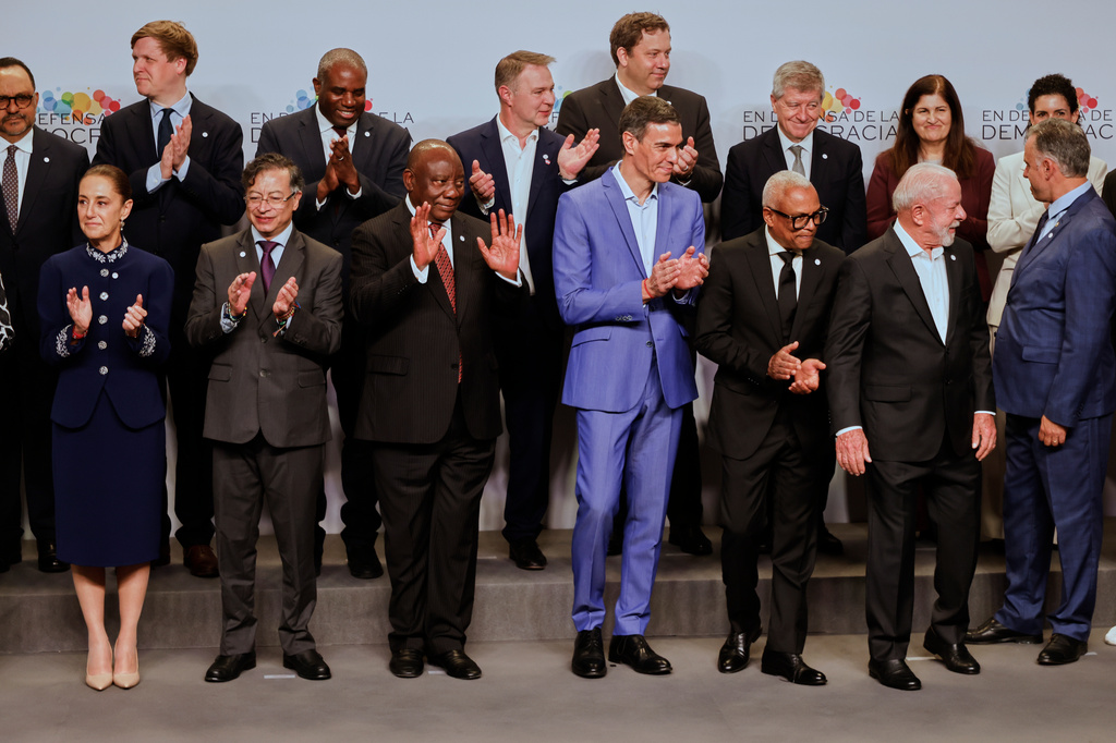 Spain's Prime Minister Pedro Sanchez, center, applauds as he poses with attendees at the Meeting in Defence of Democracy summit, in Barcelona, Spain, Saturday, April 18, 2026. (AP Photo/Joan Monfort)