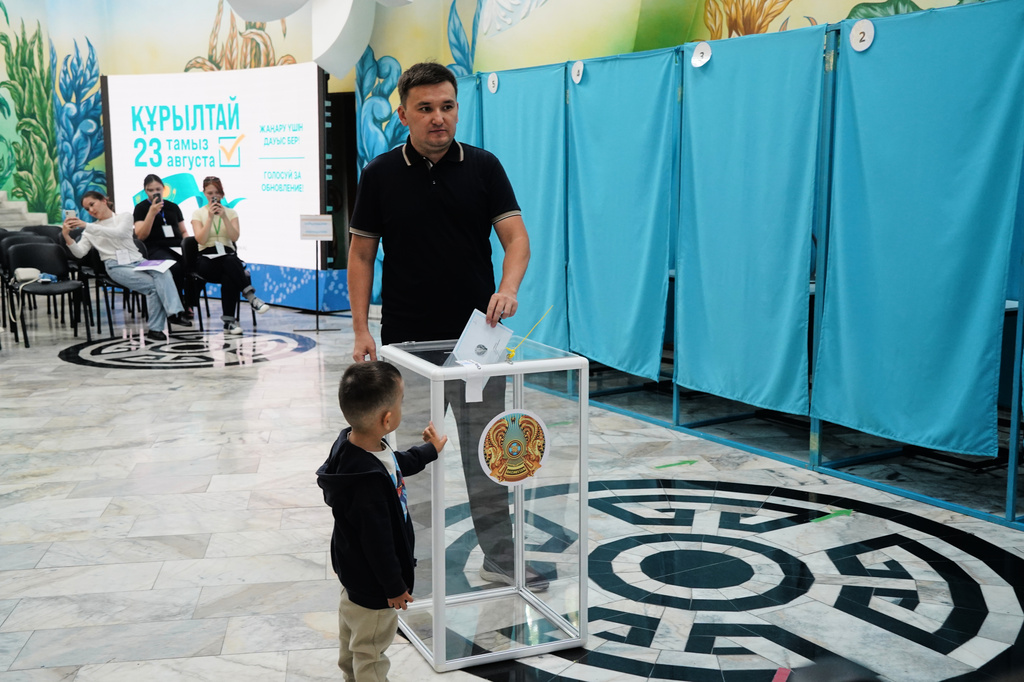 A man casts his ballot at a polling station during early parliamentary elections in Almaty, Kazakhstan, Sunday, Aug. 23, 2026. (AP Photo/Vladimir Tretyakov)