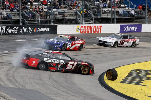 Cody Ware (51) loses a tire as leaders William Byron (24) and Ryan Blaney (12) try to drive past during a NASCAR Cup series auto race in Martinsville, Va., Sunday, Oct. 26, 2025. (AP Photo/Terry Renna) Cody Ware (51) loses a tire as leaders William Byron (24) and Ryan Blaney (12) try to drive past during a NASCAR Cup series auto race in Martinsville, Va., Sunday, Oct. 26, 2025. (AP Photo/Terry Renna)