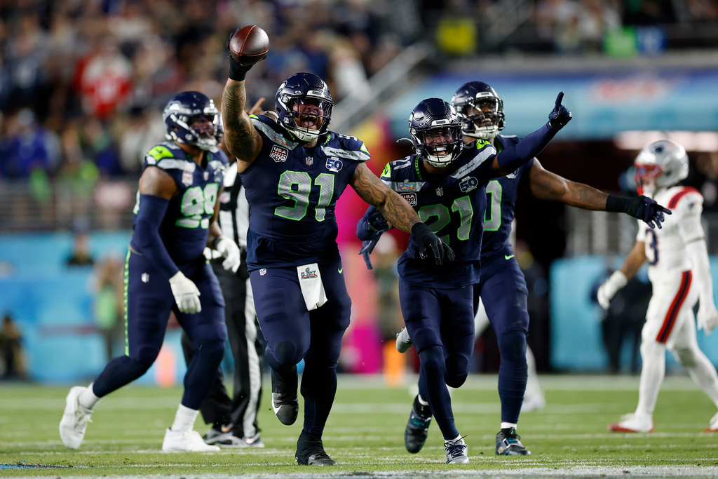 Seattle Seahawks Byron Murphy II (91), Devon Witherspoon (21), and the Seahawks defense celebrate after Murphy recovered a fumble after a sack during the third quarter of Super Bowl 60 in Santa Clara, Calif., Sunday, Feb. 8, 2026. (Scott Strazzante/San Francisco Chronicle via AP)
