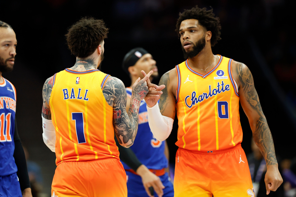 Charlotte Hornets forward Miles Bridges (0) celebrates with guard LaMelo Ball (1) after a basket against the New York Knicks during the first half of an NBA basketball game in Charlotte, N.C., Thursday, March 26, 2026. (AP Photo/Nell Redmond)