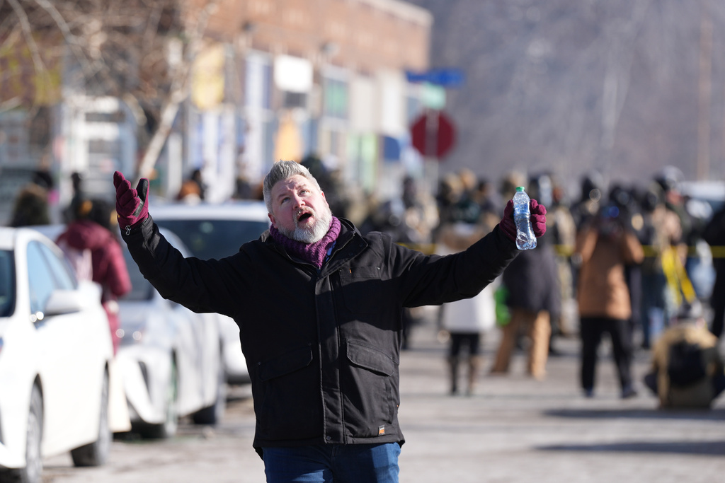 A person reacts to federal immigration officers after a shooting Saturday, Jan. 24, 2026, in Minneapolis. (AP Photo/Abbie Parr)