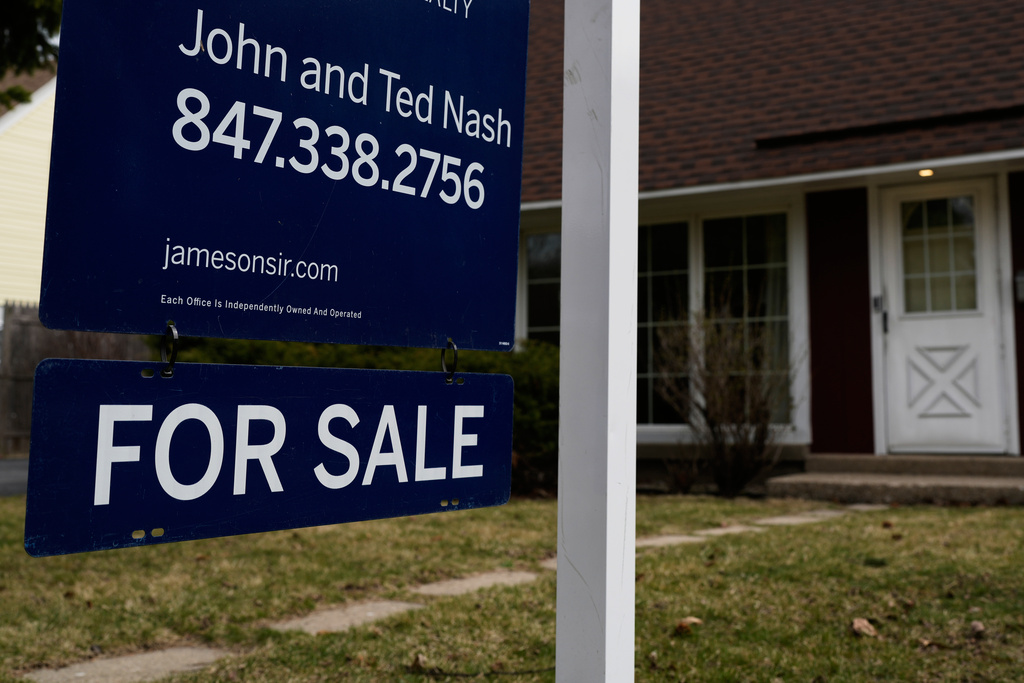 A House For Sale sign is displayed in front of a home in Evanston, Ill.,Wednesday, March 25, 2026. (AP Photo/Nam Y. Huh)
