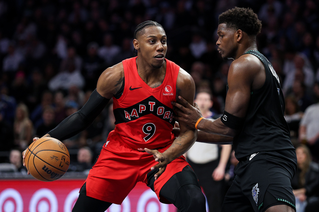 Toronto Raptors forward RJ Barrett, left, drives toward the basket as Minnesota Timberwolves guard Anthony Edwards defends during the first half of an NBA basketball game, Thursday, March 5, 2026, in Minneapolis. (AP Photo/Matt Krohn)