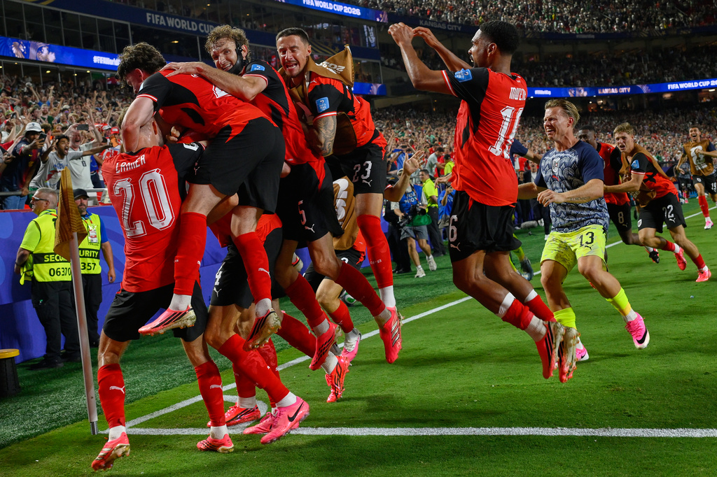 Austria's players celebrates after Austria's Sasa Kalajdzic (14) scored to tie the match during the World Cup Group J soccer match between Algeria and Austria in Kansas City, Mo., Saturday, June 27, 2026. (AP Photo/Reed Hoffmann)