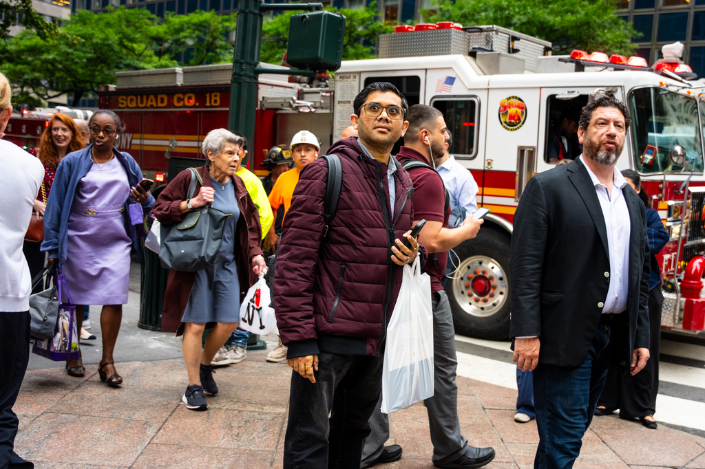 People gather near East 42nd Street after buildings in the area were evacuated, Tuesday, July 7, 2026, in New York. (AP Photo/Angelina Katsanis)