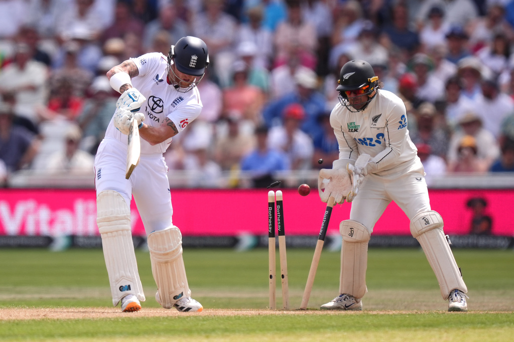 England's Ben Stokes, left, is bowled out by New Zealand's Zak Foulkes, during day three of the Third Test cricket match between England and New Zealand, in Nottingham, England, Saturday June 27, 2026. (Mike Egerton/PA via AP)