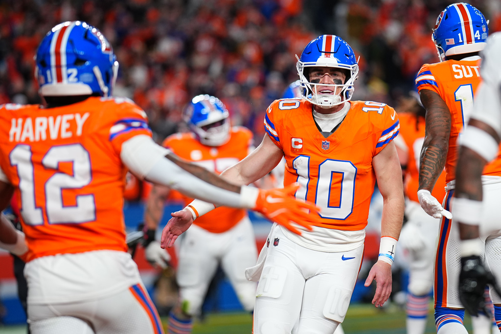 Denver Broncos quarterback Bo Nix (10) celebrates after throwing a touchdown pass during the first half of an NFL football game against the Las Vegas Raiders Thursday, Nov. 6, 2025, in Denver. (AP Photo/Jack Dempsey)