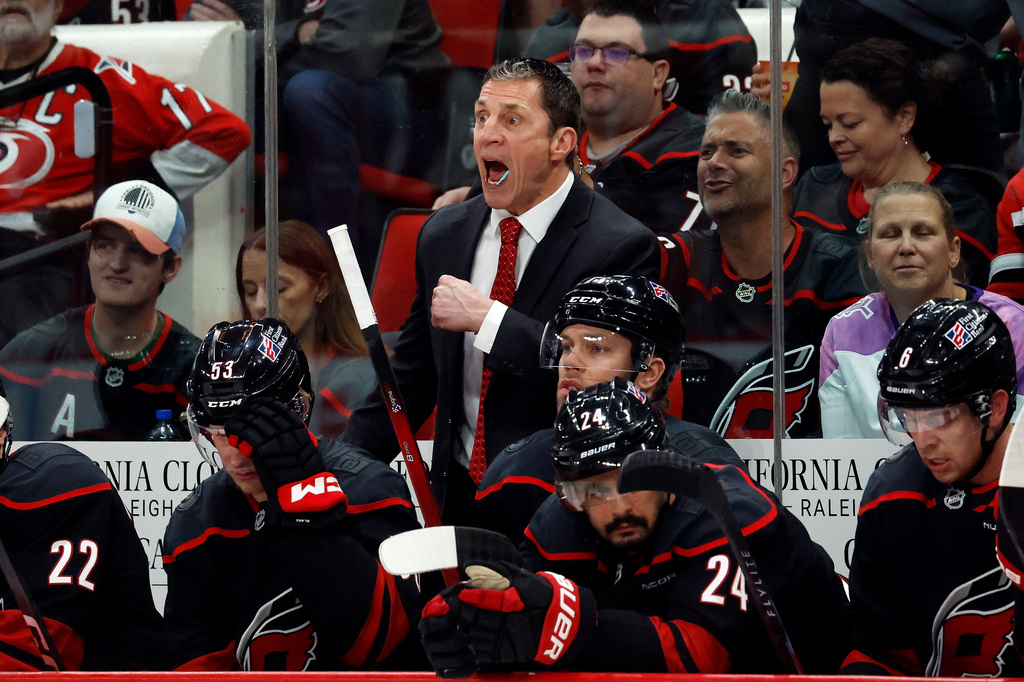 Carolina Hurricanes head coach Rod Brind'Amour, center top, protests a call during the third period of Game 2 of an NHL hockey Stanley Cup second-round playoff series against the Philadelphia Flyers in Raleigh, N.C., Monday, May 4, 2026. (AP Photo/Karl DeBlaker)