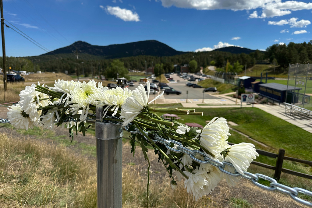 FILE - Flowers are left in remembrance of those wounded in a shooting at Evergreen High School in Evergreen, Colo., Thursday, Sept. 11, 2025. (AP Photo/Colleen Slevin, File)