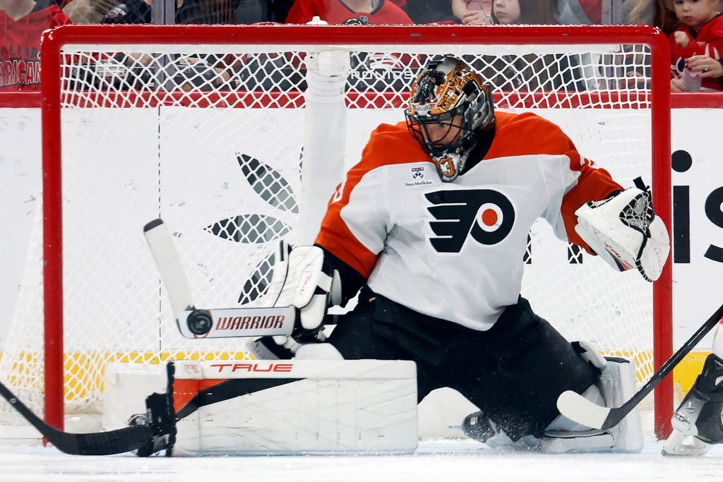 Philadelphia Flyers goaltender Samuel Ersson (33) blocks a shot from the Carolina Hurricanes during the first period of an NHL hockey game in Raleigh, N.C., Saturday, Oct. 11, 2025. (AP Photo/Karl DeBlaker)
