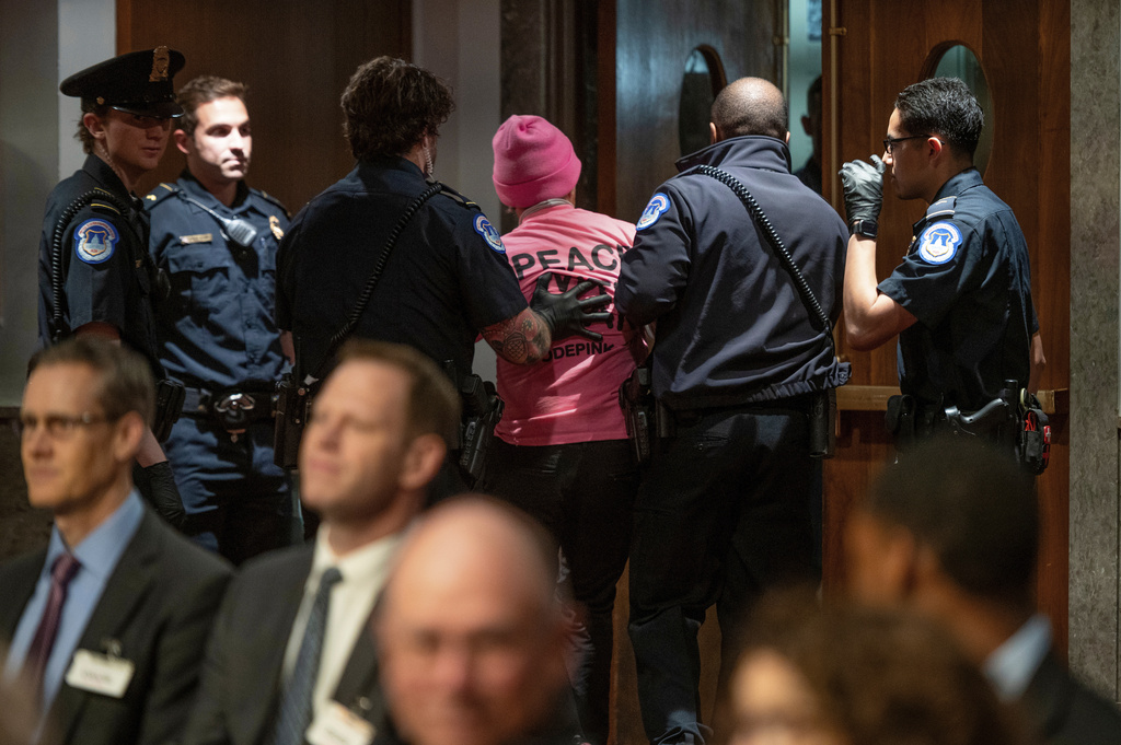 A Code Pink protestor is removed from the hearing room as Secretary of Defense Pete Hegseth testifies before the Senate Armed Services Committee, on Capitol Hill, in Washington, Thursday, April 30, 2026. (AP Photo/Cliff Owen)