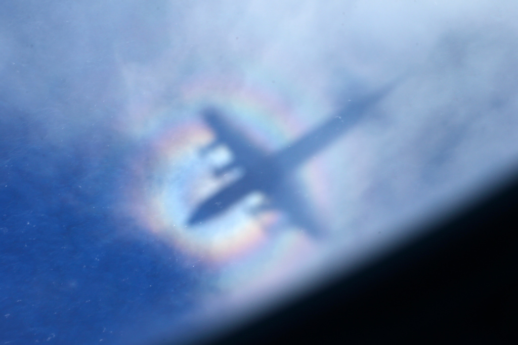 FILE -The shadow of a Royal New Zealand Air Force P3 Orion is seen on low level cloud while the aircraft searches for missing Malaysia Airlines Flight MH370 in the southern Indian Ocean, near the coast of Western Australia, March 31, 2014. (AP Photo/Rob Griffith, File)