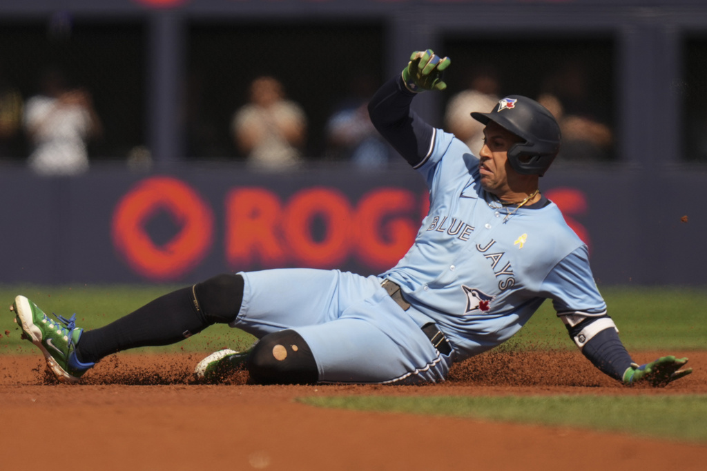 Toronto Blue Jays' George Springer slides into second base after hitting an RBI double during third-inning baseball game action against the Baltimore Orioles in Toronto, Sunday, Sept. 14, 2025. (Chris Young/The Canadian Press via AP)
