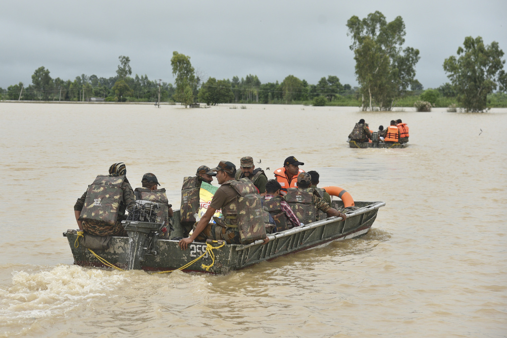 Indian army soldiers travel in boats through floodwaters to rescue the stranded people following heavy rains in Kapurthala district of northern state of Punjab, India, Tuesday, Sept. 2, 2025. (AP Photo/Prabhjot Gill)
