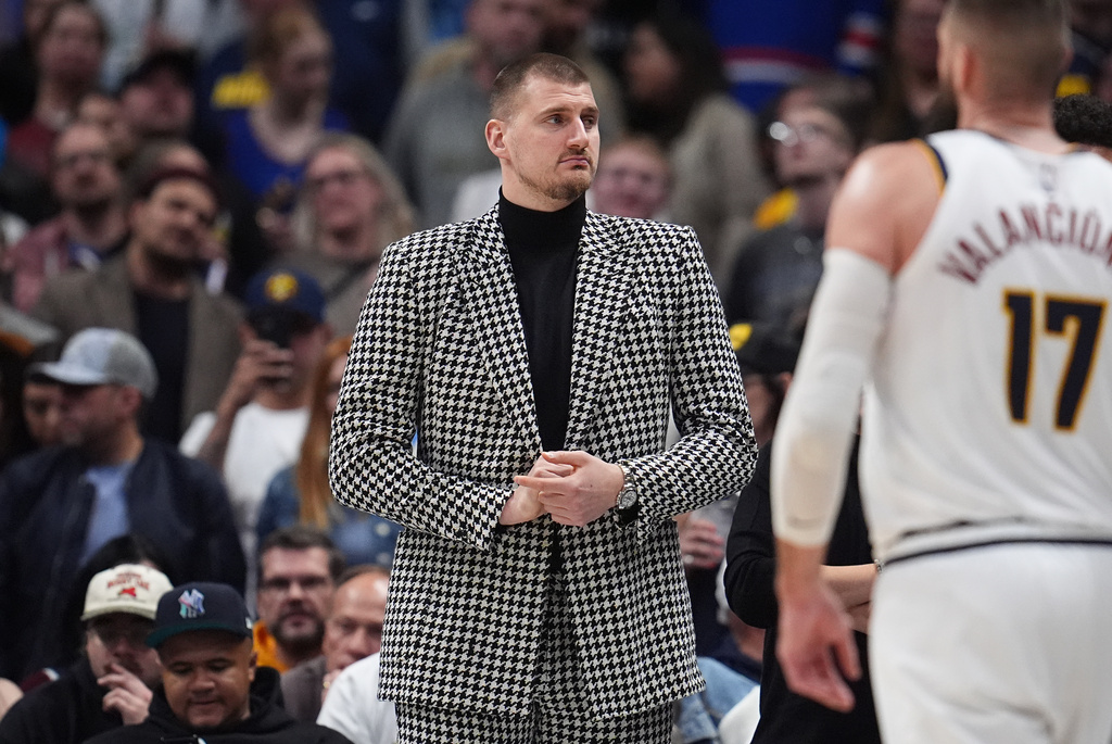 Injured Denver Nuggets center Nikola Jokić looks on from the baseline in the second half of an NBA basketball game against the Brooklyn Nets Thursday, Jan. 29, 2026, in Denver. (AP Photo/David Zalubowski)