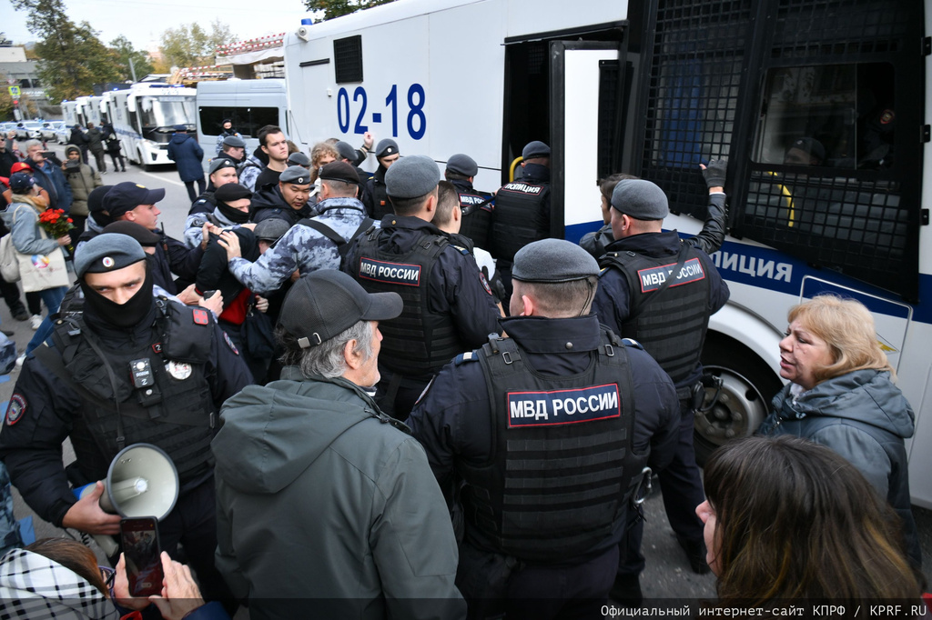 In this photo released by Russian Communist Party Press Service, Police detain demonstrators after a rally marking the 33rd anniversary of the events in memory of those who were killed during the 1993 bloody clashes between government forces and supporters of the rebellious parliament, in Moscow, on Sunday, Oct. 4, 2026. (Russian Communist Party Press Service via AP)