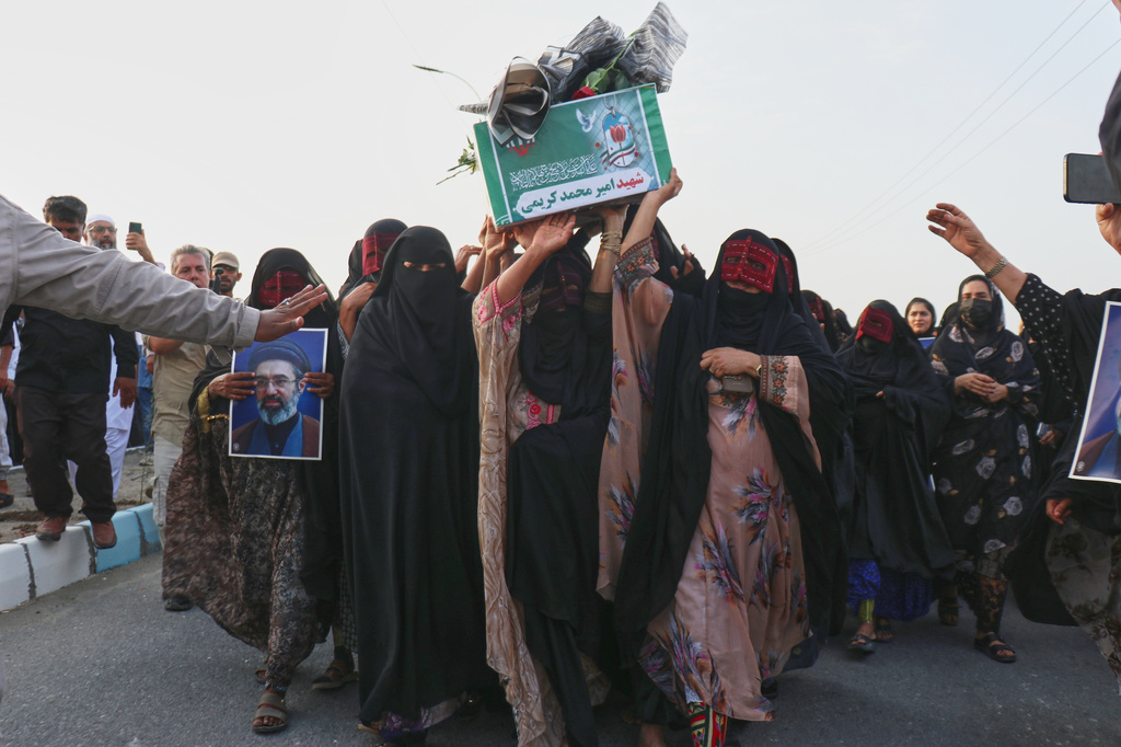 Women carry a coffin during a mass funeral for people killed when, according to Iranian media and a rights group, a U.S. missile struck a home where a wedding was being held in Kuhestak, southern Iran, Thursday, Sept. 3, 2026. (Razieh Poudat/ISNA via AP)