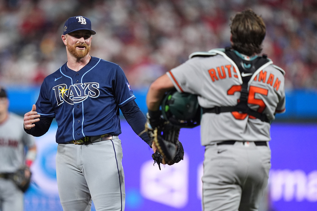 Tampa Bay Rays pitcher Drew Rasmussen talks with Baltimore Orioles catcher Adley Rutschman during the seventh inning of the MLB baseball All-Star Game between the American League and National League, Tuesday, July 14, 2026, in Philadelphia. (AP Photo/Matt Rourke)
