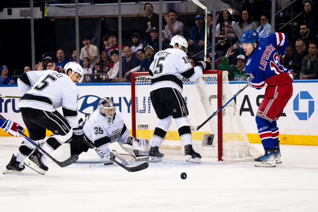 Los Angeles Kings players scramble to save the puck during the first period of an NHL hockey game against the New York Rangers, Monday, March 16, 2026, in New York. (AP Photo/Angelina Katsanis)