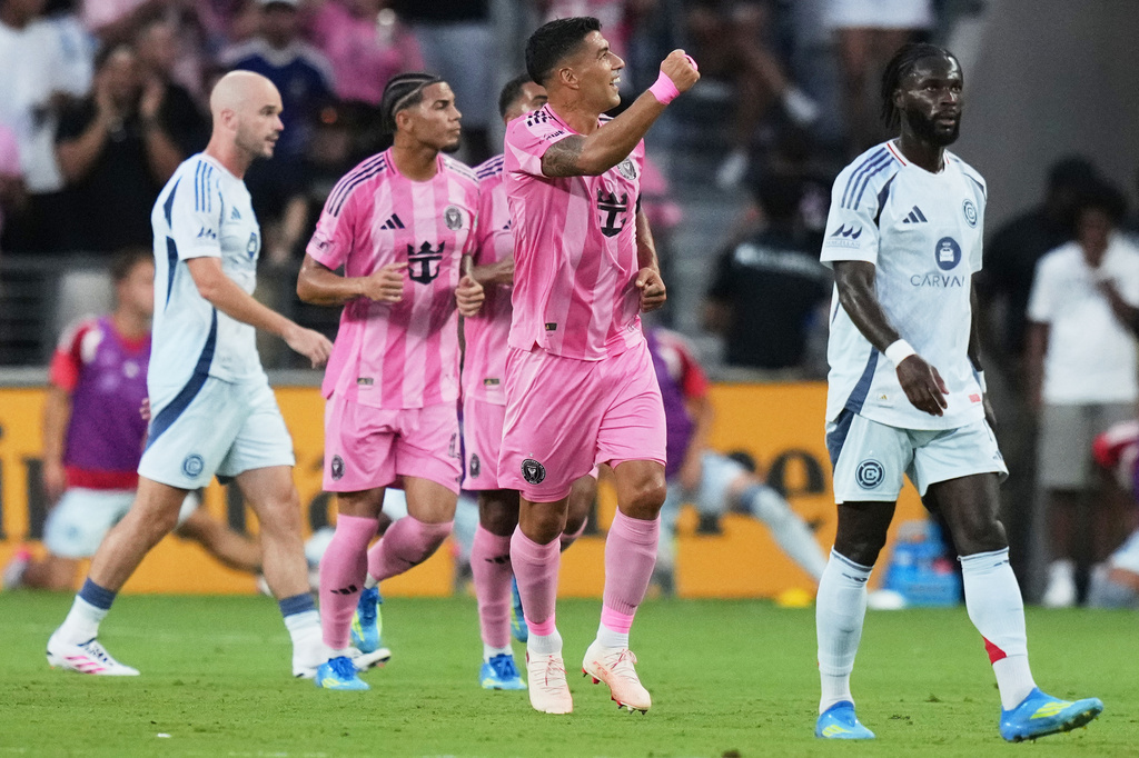 Inter Miami forward Luis Suárez, center, reacts after scoring a goal during the first half of an MLS soccer match against the Chicago Fire, Wednesday, July 22, 2026, in Miami. (AP Photo/Lynne Sladky)