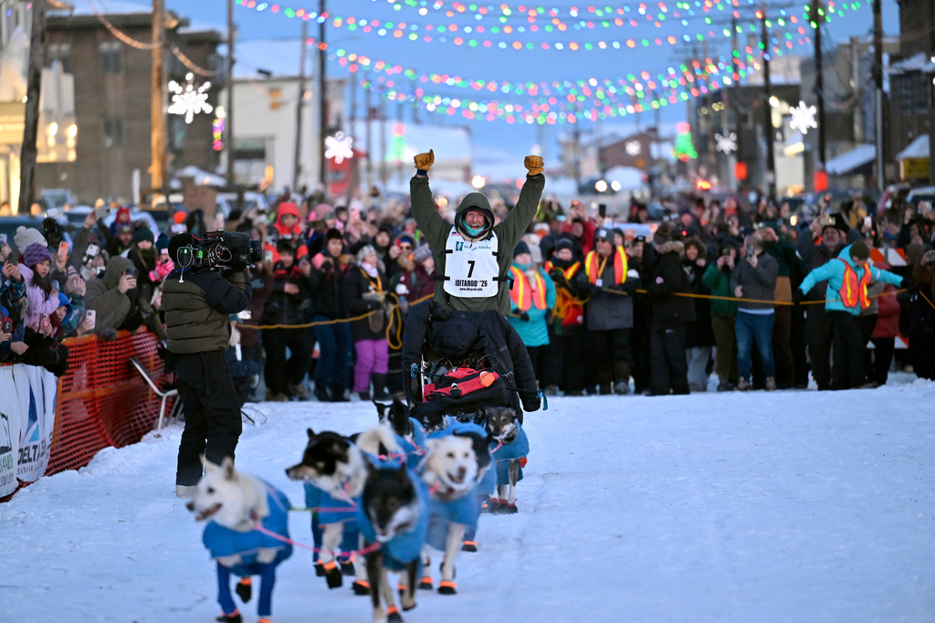 Jessie Holmes arrives first to the finish lane, claiming his second straight Iditarod Trail Sled Dog Race championship, in Nome, Alaska, Tuesday March 17, 2026. (Marc Lester/Anchorage Daily News via AP)