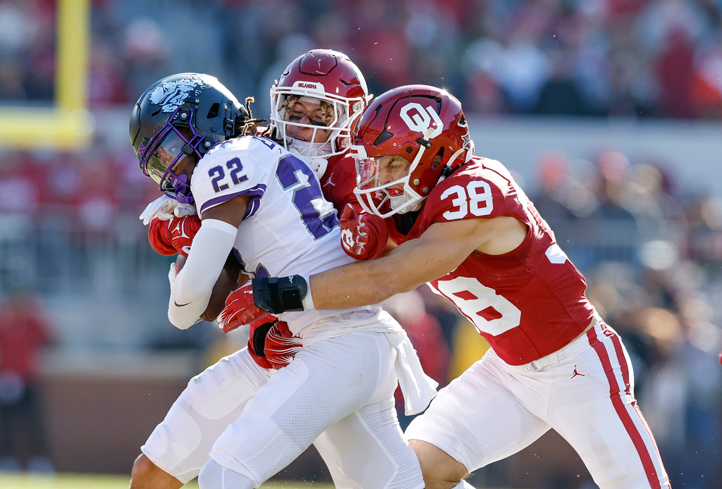 FILE - Oklahoma linebacker Owen Heinecke (38) tackles TCU wide receiver Major Everhart (22) during the second half of an NCAA college football game, Nov. 24, 2023, in Norman, Okla. (AP Photo/Alonzo Adams, File)