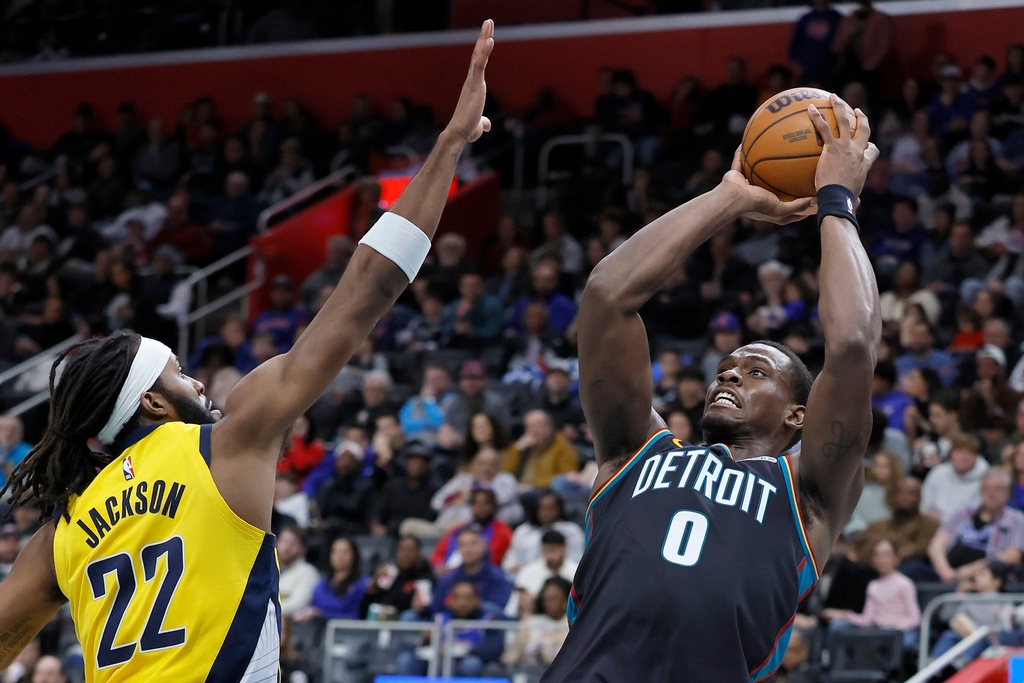 Detroit Pistons center Jalen Duren (0) takes a shot against Indiana Pacers forward Isaiah Jackson (22) during the first half of an NBA basketball game Saturday, Jan. 17, 2026, in Detroit. (AP Photo/Duane Burleson)