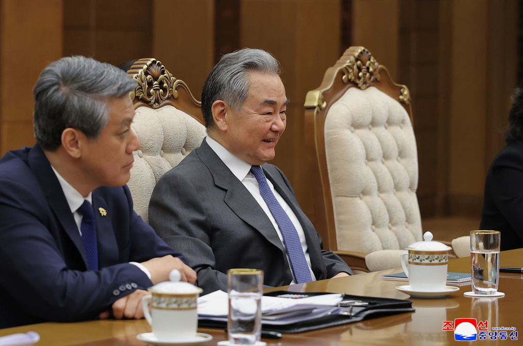 In this photo provided by the North Korean government, Chinese Foreign Minister Wang Yi, right, reacts as he speaks with North Korean leader Kim Jong Un in Pyongyang, North Korea, Friday, April 10, 2026. Independent journalists were not given access to cover the event depicted in this image distributed by the North Korean government. The content of this image is as provided and cannot be independently verified. Korean language watermark on image as provided by source reads: "KCNA" which is the abbreviation for Korean Central News Agency. (Korean Central News Agency/Korea News Service via AP)