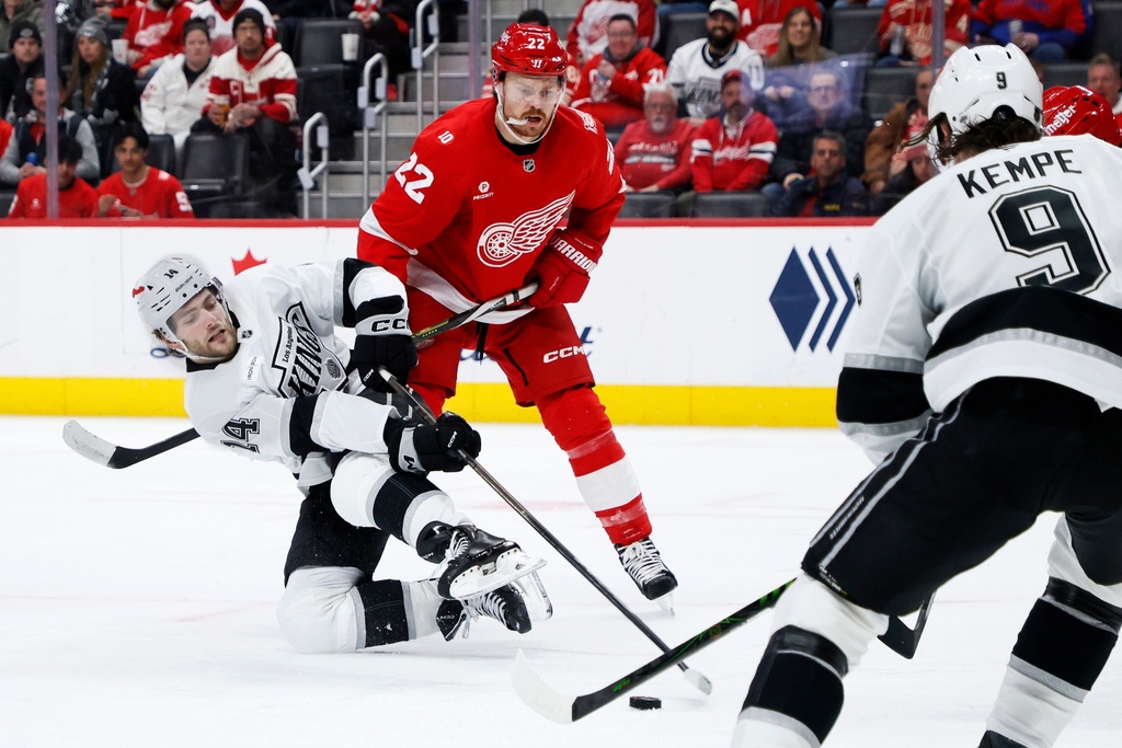 Los Angeles Kings right wing Alex Laferriere (14) tries to get a shot off against Detroit Red Wings center Mason Appleton (22) during the second period of an NHL hockey game Tuesday, Jan. 27, 2026, in Detroit. (AP Photo/Duane Burleson)