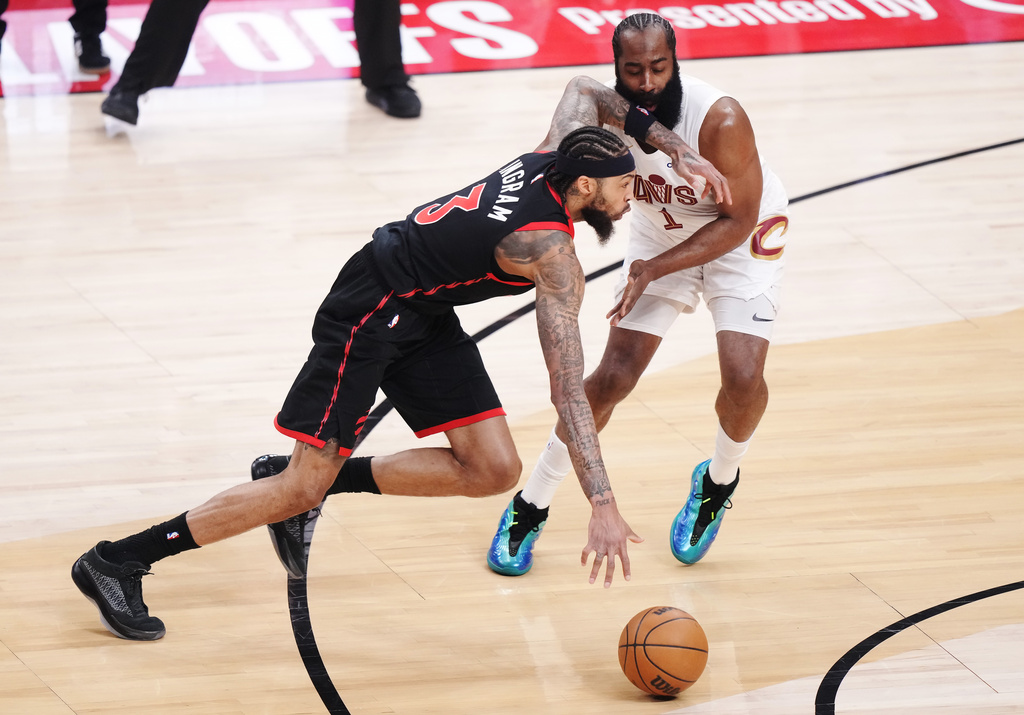 Toronto Raptors' Brandon Ingram (3) drives past Cleveland Cavaliers' James Harden (1) during the first half of an NBA playoff basketball game in Toronto on Thursday, April 23, 2026. (Nathan Denette/The Canadian Press via AP)