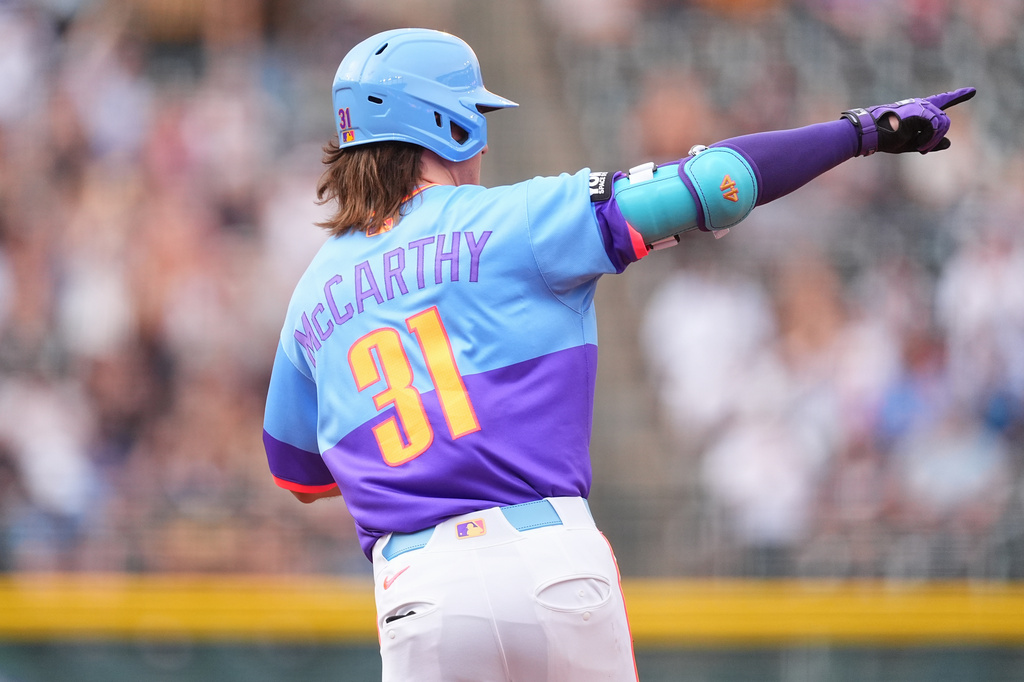 Colorado Rockies' Jake McCarthy gestures to the bullpen as he circles the bases after hitting a solo home run off San Francisco Giants starting pitcher Logan Webb in the first inning of a baseball game Friday, July 3, 2026, in Denver. (AP Photo/David Zalubowski)