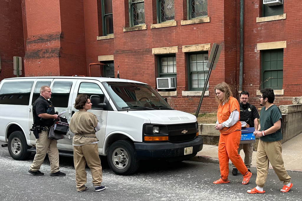 Deputies escort Michelle Zajko, left, Daniel Blank, right, and Jack LaSota, in orange, from the Allegany County Courthouse after a pretrial hearing in Cumberland, Md., on Friday, January 16, 2026. (AP Photo/Mark Scolforo)