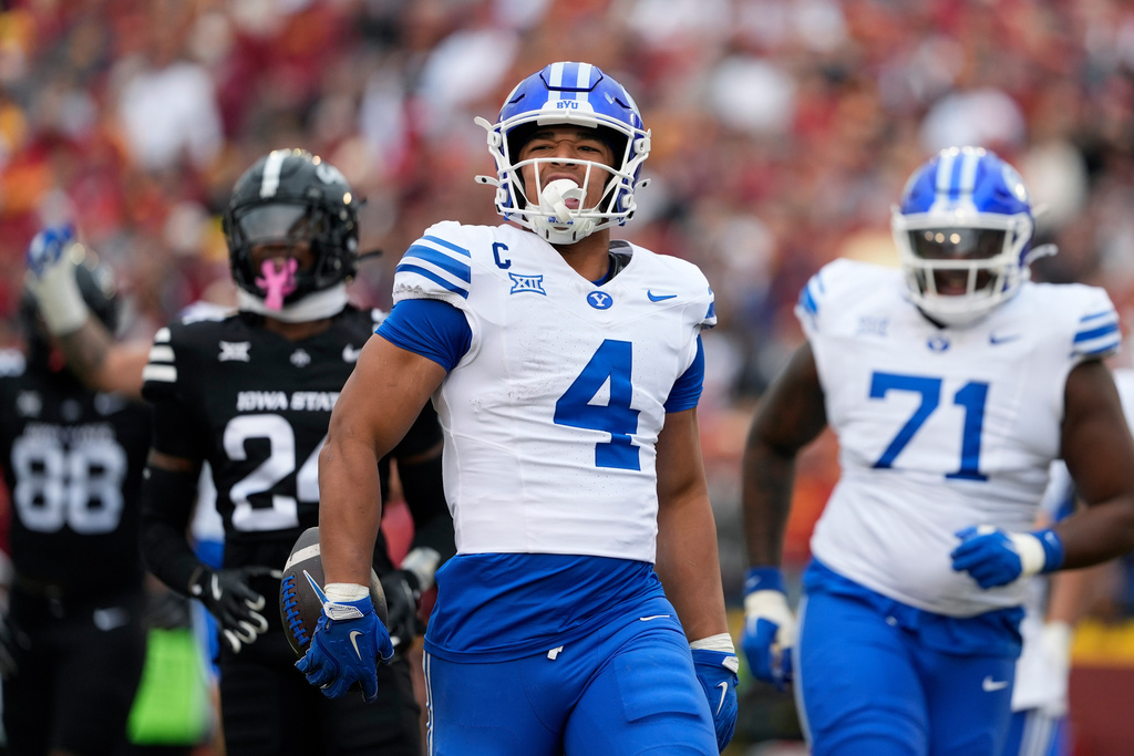 BYU running back LJ Martin (4) runs in a touchdown against Iowa State during the first half of an NCAA college football game, Saturday, Oct. 25, 2025, in Ames, Iowa. (AP Photo/Matthew Putney)