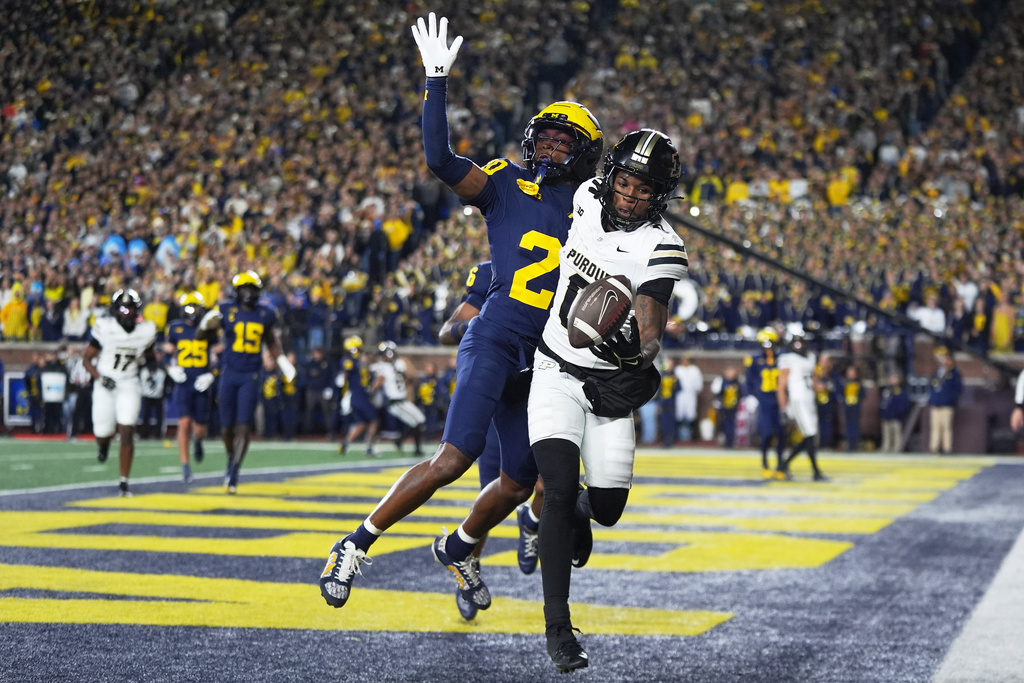 Purdue wide receiver Nitro Tuggle, right, is unable to catch a pass against Michigan defensive back Jyaire Hill during the first half of an NCAA college football game, Saturday, Nov. 1, 2025, in Ann Arbor, Mich. (AP Photo/Ryan Sun)