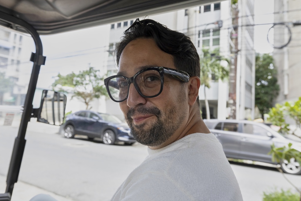 Lin-Manuel Miranda rides a golf cart during the closing event of the Flamboyan Arts Fund in San Juan, Puerto Rico, Saturday, Sept. 13, 2025. (AP Photo/Alejandro Granadillo)