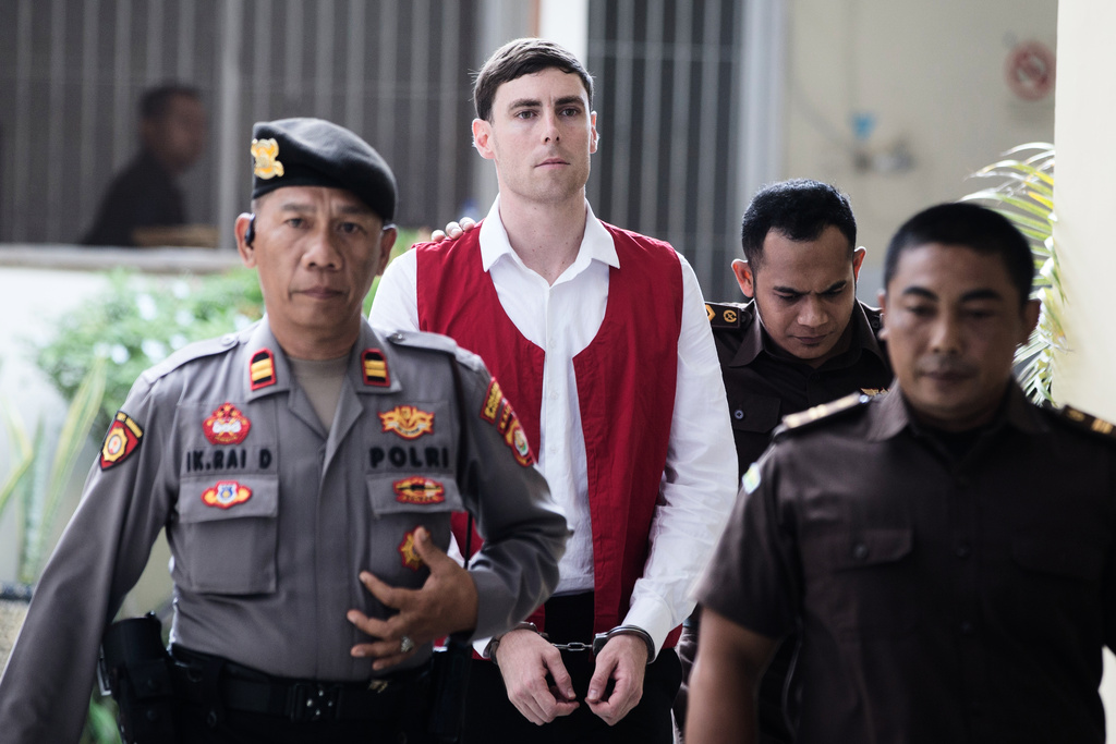 Australian national Darcy Jenson, center, who is on trial for the fatal shooting of an Australian tourist last year, arrives for his sentencing hearing at the district court, in Denpasar, Bali, Indonesia, Monday, March 9, 2026. (AP Photo/Firdia Lisnawati)