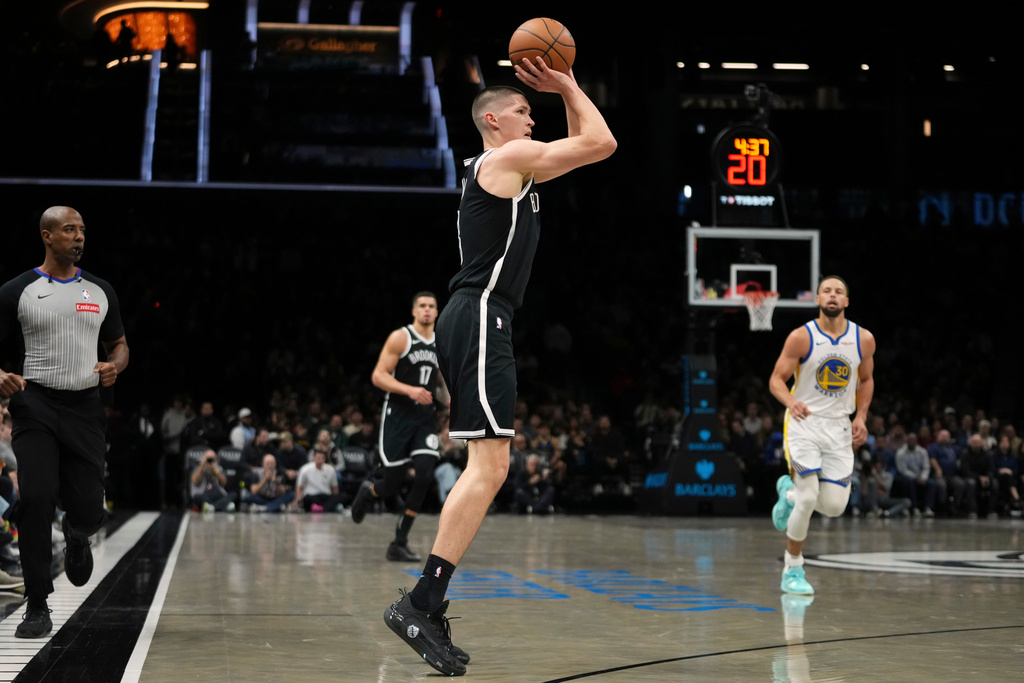 Brooklyn Nets' Egor Demin (8) shoots over Golden State Warriors' Stephen Curry (30) during the first half of an NBA basketball game Monday, Dec. 29, 2025, in New York. (AP Photo/Frank Franklin II)